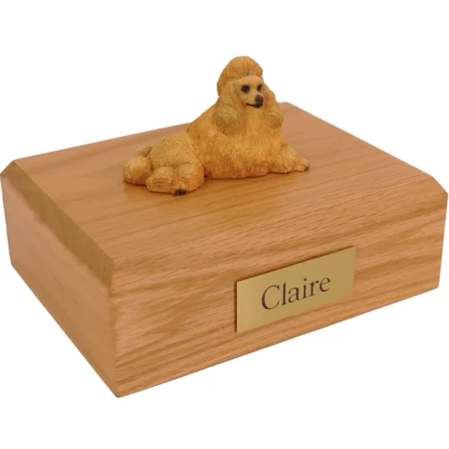 Laying Apricot Poodle dog figurine on wood cremation urn