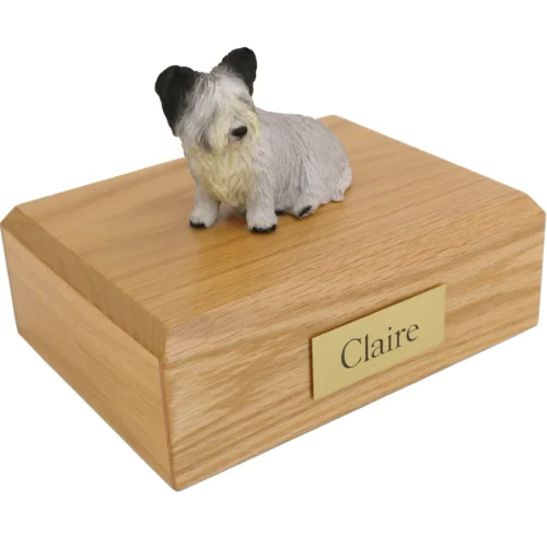 Sitting skye terrier dog figurine on wood cremation urn