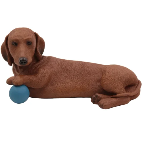 Laying red Dachshund with ball dog figurine for cremation urn