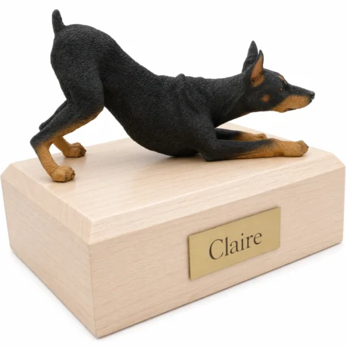 Memorial cremation urn with black Doberman Pinscher (pincher) dog figurine, maple finish