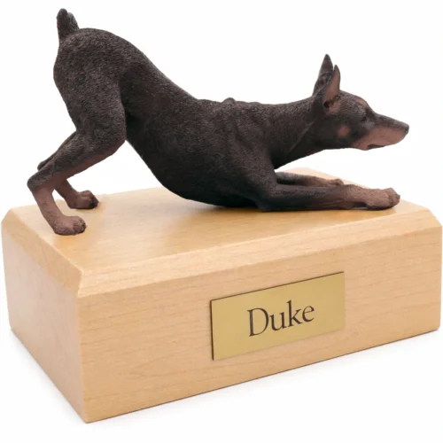 Memorial cremation urn with red ears up Doberman Pinscher dog figurine, maple finish