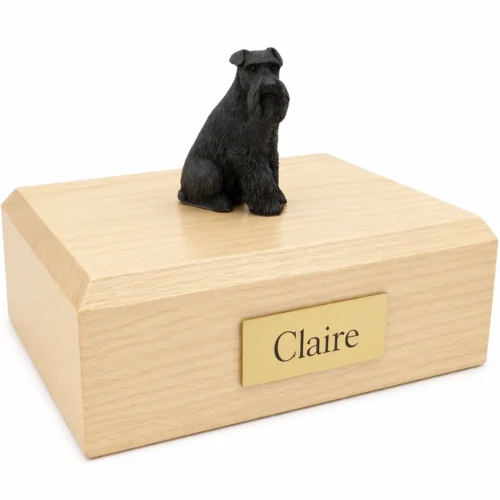 Memorial cremation urn with sitting ears down black Schnauzer dog figurine, maple finish
