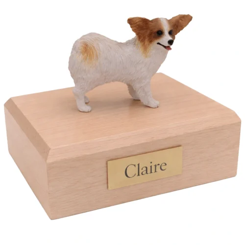 Memorial cremation urn with standing brown and white Papillon dog figurine, maple finish