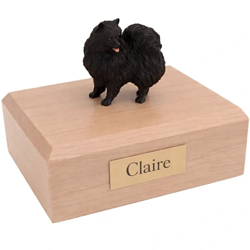 Memorial cremation urn with standing black Pomeranian dog figurine, maple finish