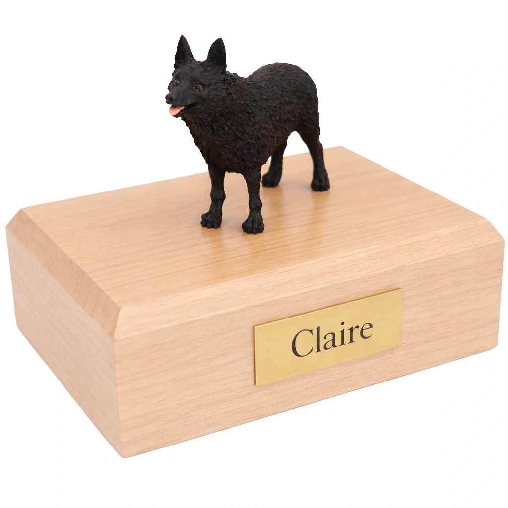 Memorial cremation urn with standing black Schipperke dog figurine, maple finish