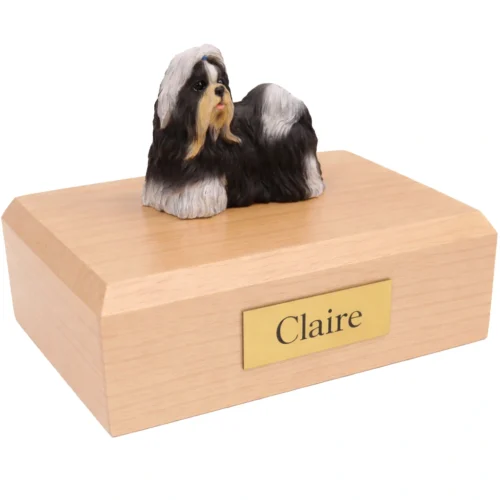 Memorial cremation urn with standing black and white Shih Tzu dog figurine, maple finish