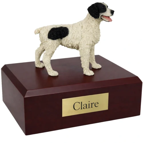 Memorial cremation urn with standing black and white Brittany Spaniel dog figurine, walnut finish