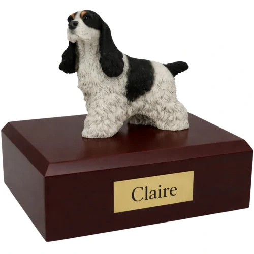 Memorial cremation urn with standing black and white Cocker Spaniel dog figurine, walnut finish
