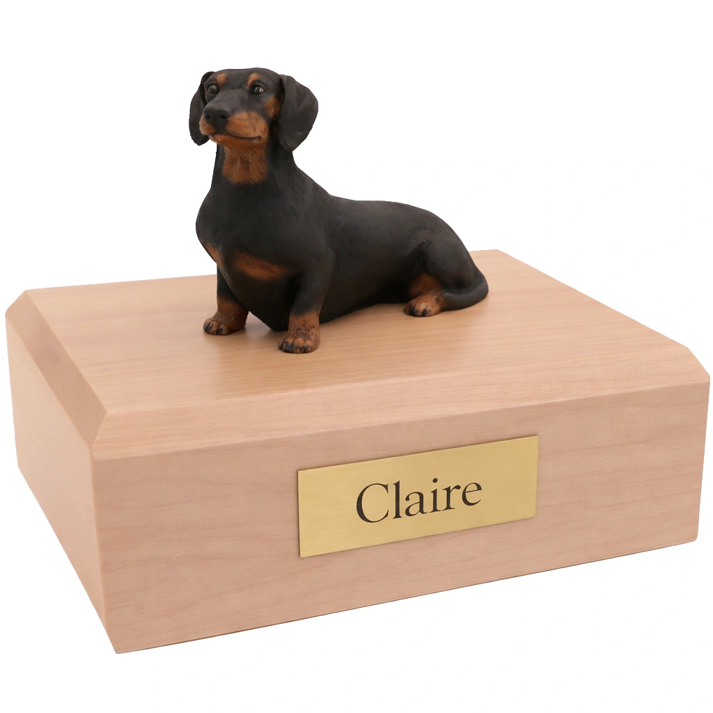 Memorial cremation urn with sitting black Dachshund dog figurine, maple finish