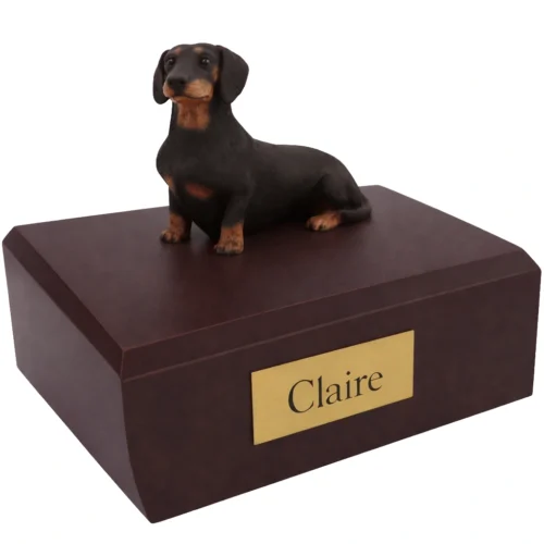 Memorial cremation urn with sitting black Dachshund dog figurine, walnut finish