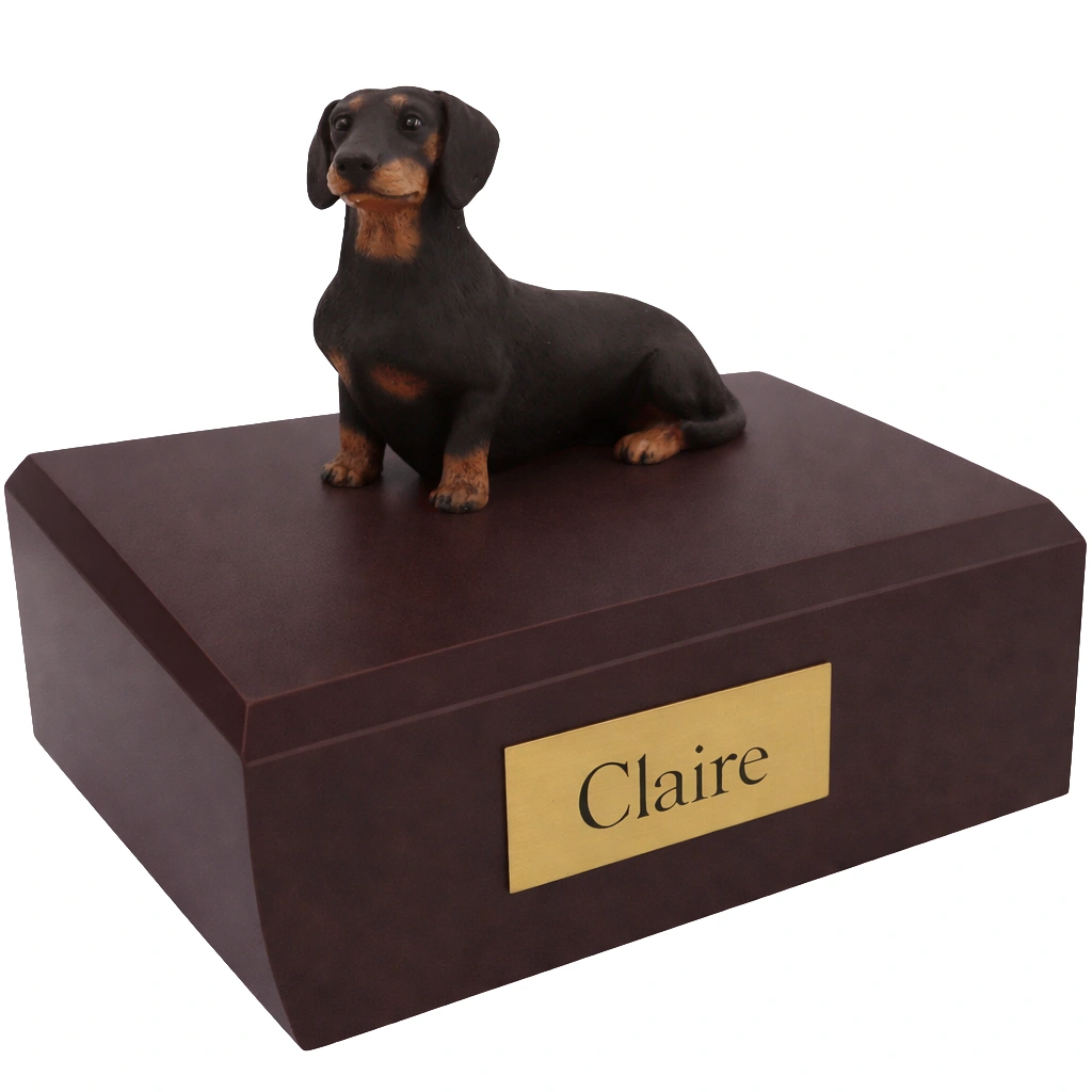 Memorial cremation urn with sitting black Dachshund dog figurine, walnut finish