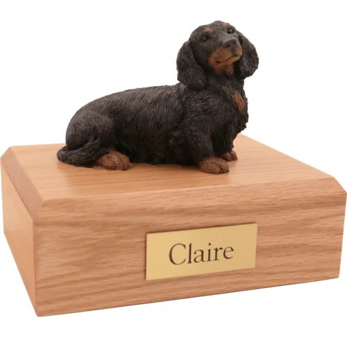 Memorial cremation oak finish urn with sitting longhaired black and red Dachshund dog figurine