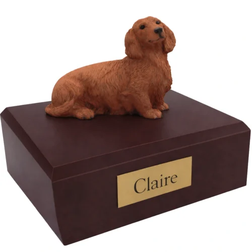 Memorial cremation urn with sitting long haired red Dachshund dog figurine, walnut finish