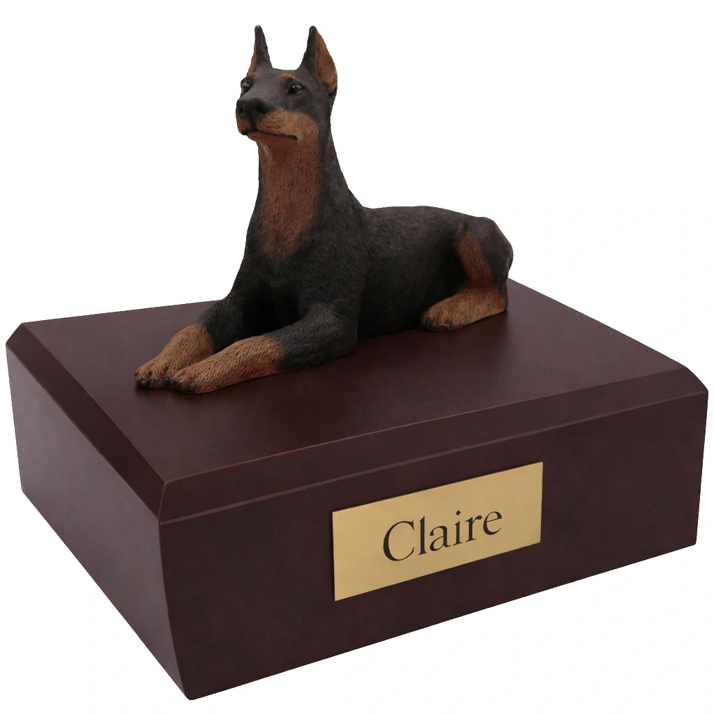 Memorial cremation urn with laying ears up Doberman Pinscher dog figurine, walnut finish