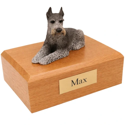 Memorial cremation urn with laying ears up black and silver Schnauzer dog figurine, oak finish
