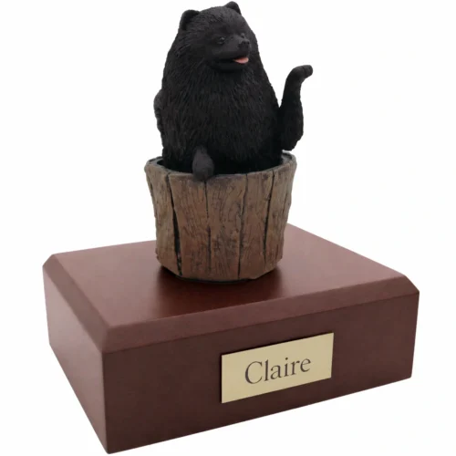 Memorial cremation urn with black Pomeranian dog figurine, walnut finish