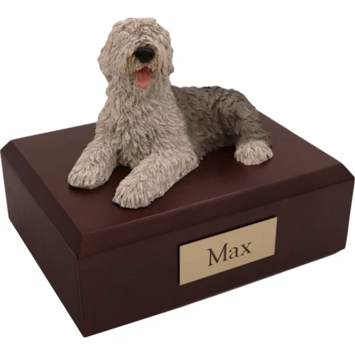 Memorial cremation urn with laying Sheepdog dog figurine, walnut finish