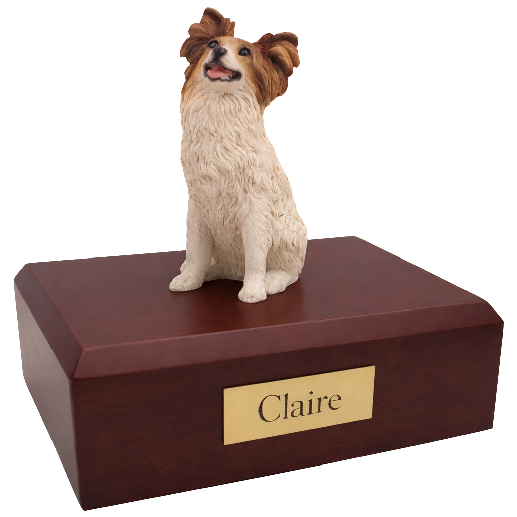 Memorial cremation urn with sitting brown and white Papillon dog figurine, maple finish