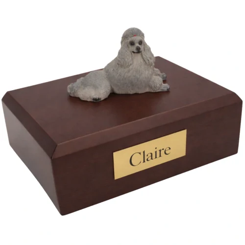 Memorial cremation urn with laying gray Poodle dog figurine, walnut finish