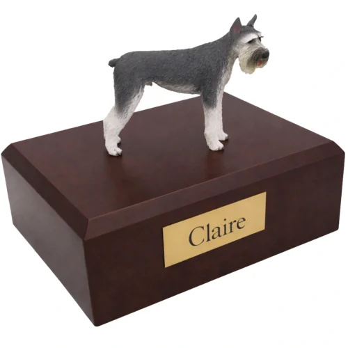 Memorial cremation urn with standing gray and white Giant Schnauzer dog figurine, walnut finish