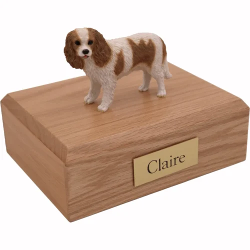 Memorial cremation urn with standing brown and white King Charles Spaniel dog figurine, oak finish