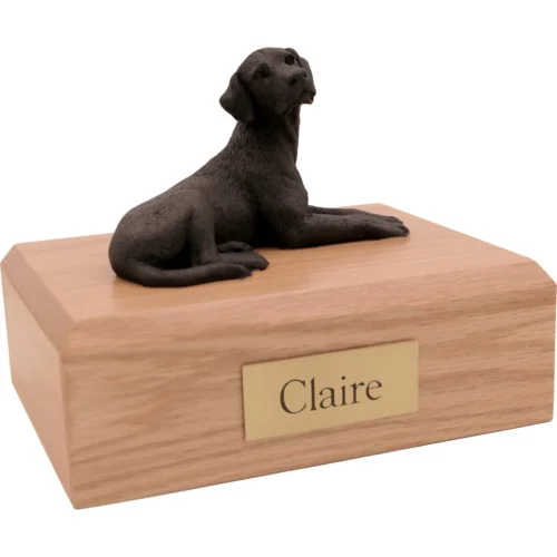 Memorial cremation urn with laying black Labrador Retriever dog figurine, oak finish