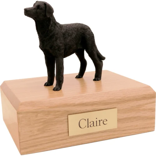 Memorial cremation urn with standing black Labrador Retriever dog figurine, oak finish