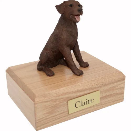 Memorial cremation urn with sitting chocolate Labrador Retriever dog figurine, oak finish