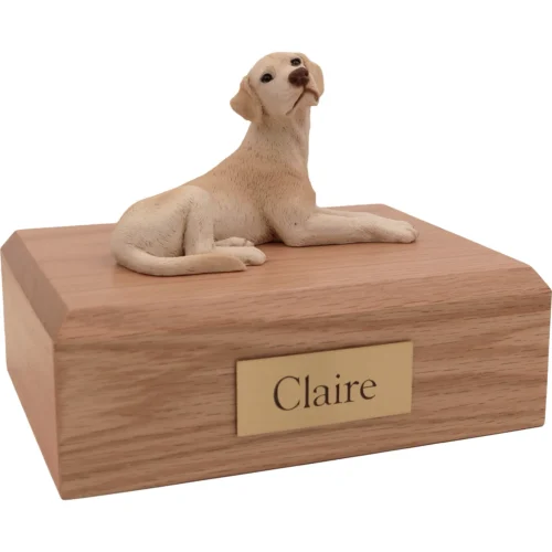 Memorial cremation urn with laying yellow Labrador Retriever dog figurine, oak finish