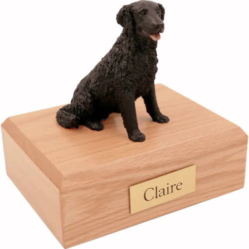 Memorial cremation urn with sitting black Labrador Retriever dog figurine, oak finish