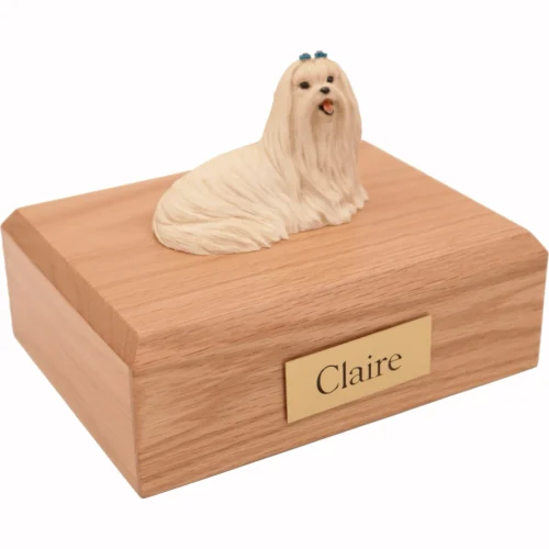 Memorial cremation urn with laying Maltese dog figurine, oak finish