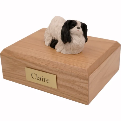 Memorial cremation urn with black and white Pekingese dog figurine, oak finish