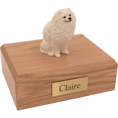 Memorial cremation urn with sitting white Pomeranian dog figurine, oak finish