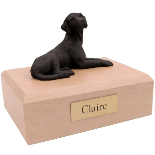 Memorial cremation urn with laying black Labrador Retriever dog figurine, maple finish