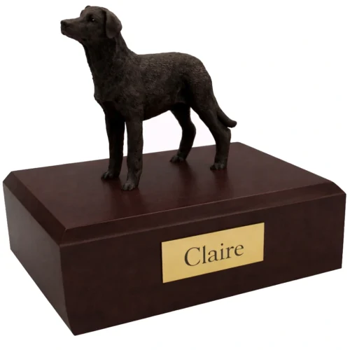 Memorial cremation urn with standing black Labrador Retriever dog figurine, walnut finish