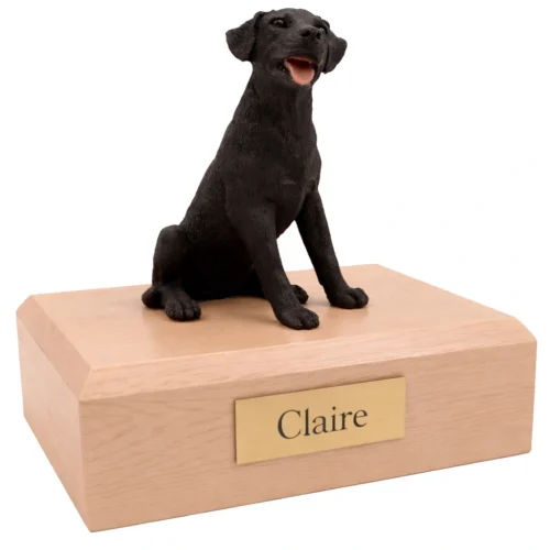 Memorial cremation urn with sitting black Labrador Retriever dog figurine, maple finish