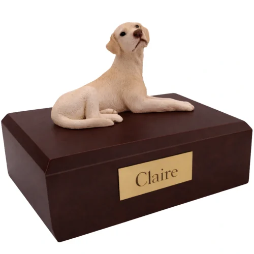 Memorial cremation urn with laying yellow Labrador Retriever dog figurine, walnut finish