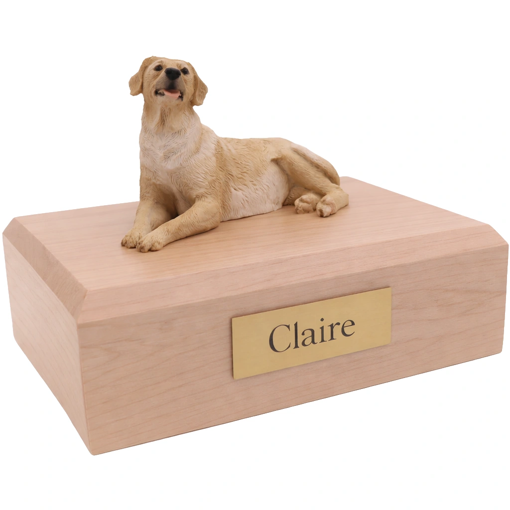 Memorial cremation urn with laying yellow Labrador Retriever dog figurine, maple finish