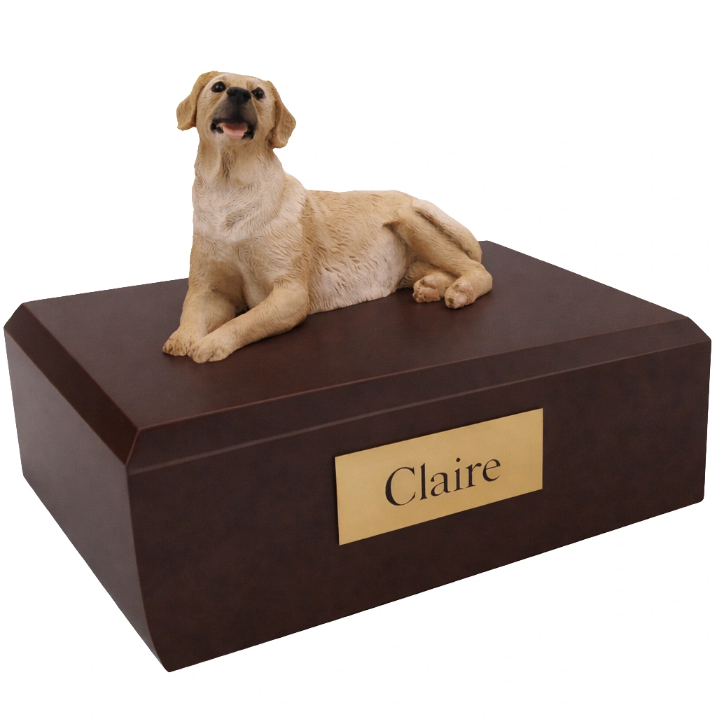 Memorial cremation urn with laying yellow Labrador Retriever dog figurine, walnut finish