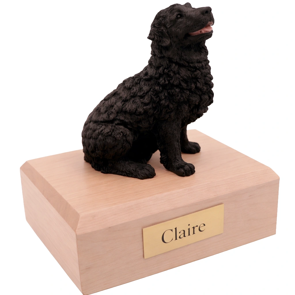 Memorial cremation urn with sitting black Newfoundland dog figurine, maple finish
