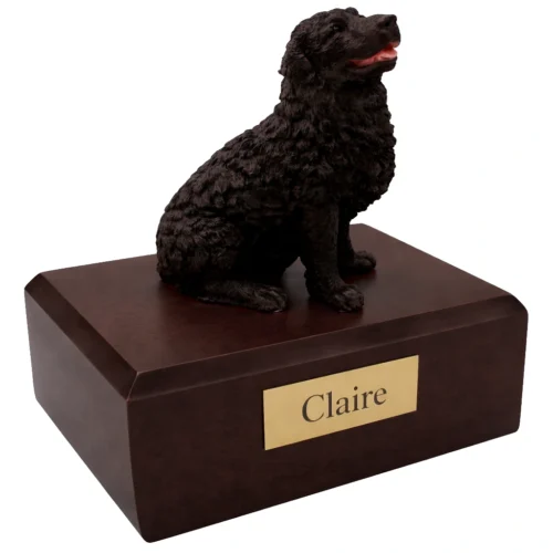 Memorial cremation urn with sitting black Newfoundland dog figurine, walnut finish