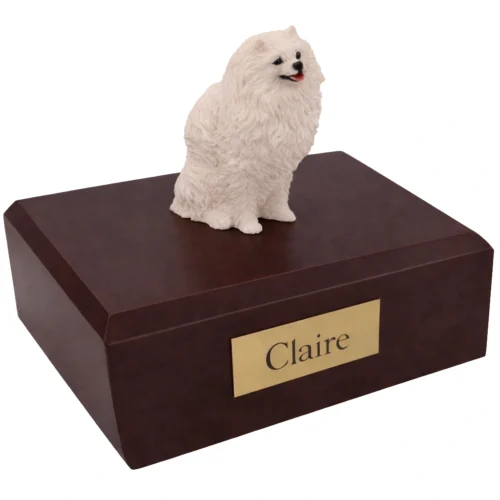 Memorial cremation urn with sitting white Pomeranian dog figurine, walnut finish