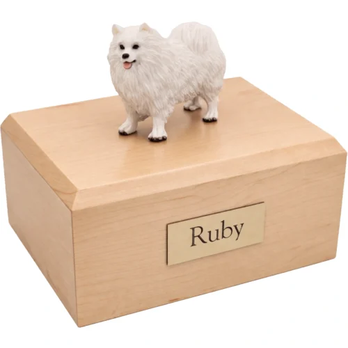 Memorial cremation urn with standing white Samoyed dog figurine, maple finish