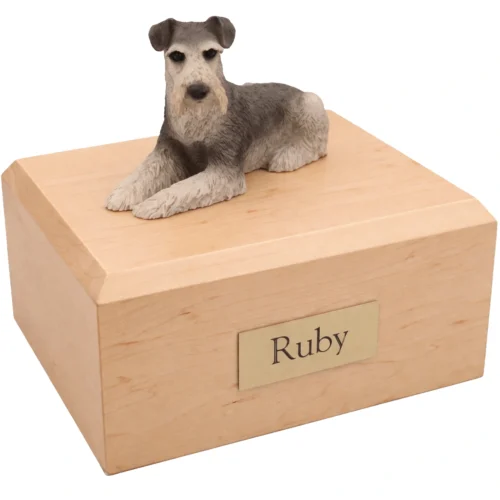 Memorial cremation urn with laying gray ears down Schnauzer dog figurine, maple finish