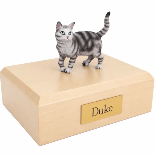 Memorial cremation urn with standing silver shorthaired tabby cat figurine, maple finish