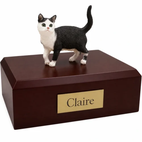 Memorial cremation urn with standing black and white shorthaired tuxedo cat figurine, walnut finish