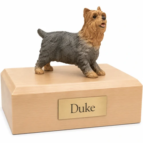 Memorial cremation urn with standing Yorkie dog figurine, maple finish