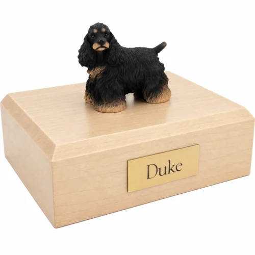 Memorial cremation urn with standing black and brown Cocker Spaniel dog figurine, maple finish