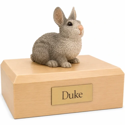Memorial cremation urn with gray and white rabbit figurine, maple finish