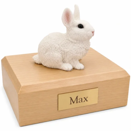 Memorial cremation urn with white rabbit figurine, maple finish